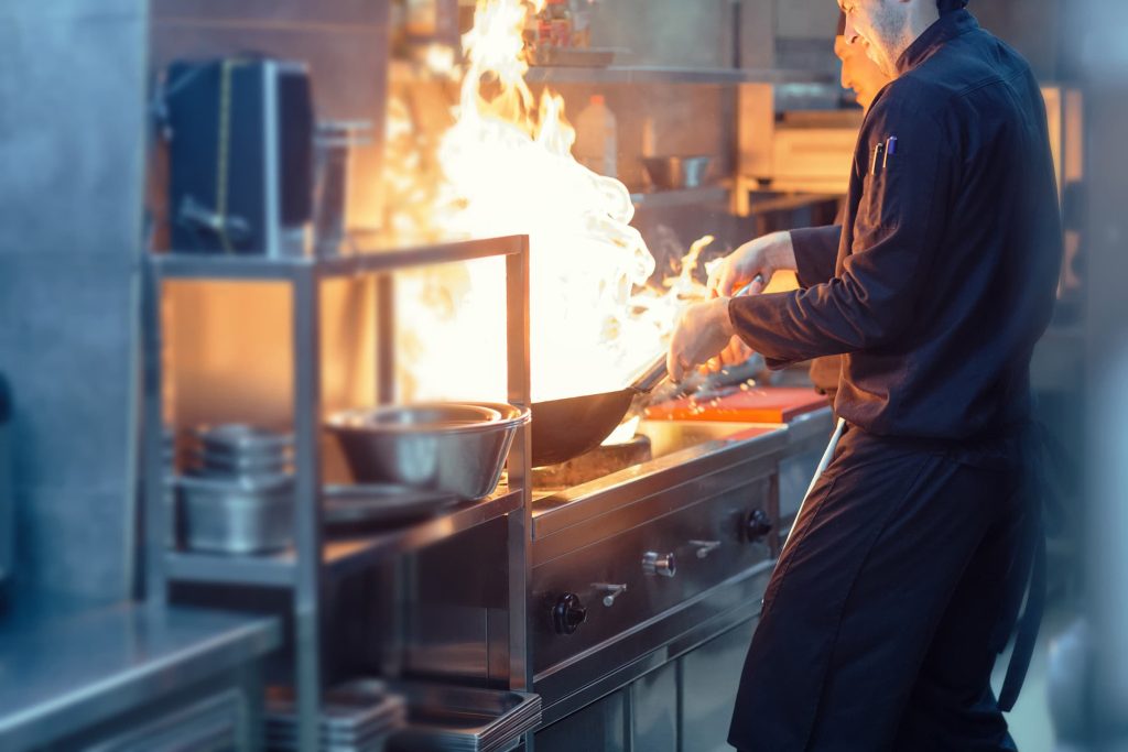 Chef cooking with a wok.