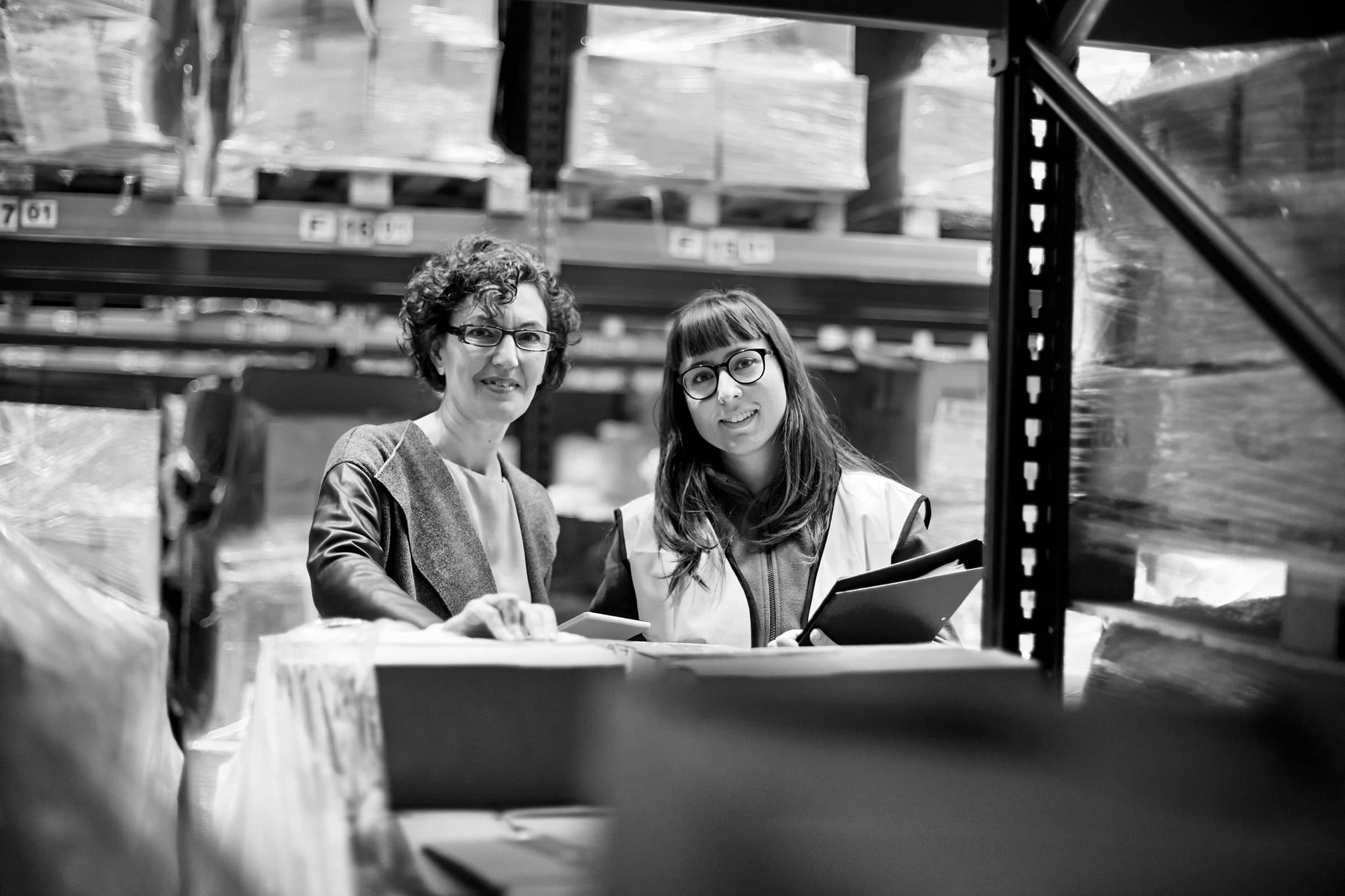 Two women in a warehouse.