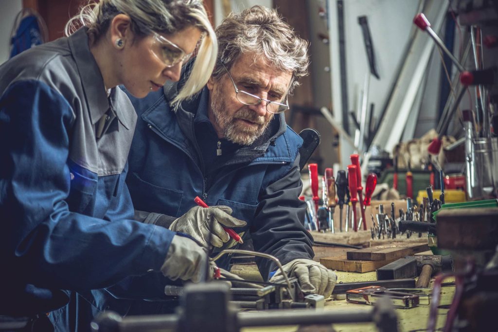 Two people working in a workshop.